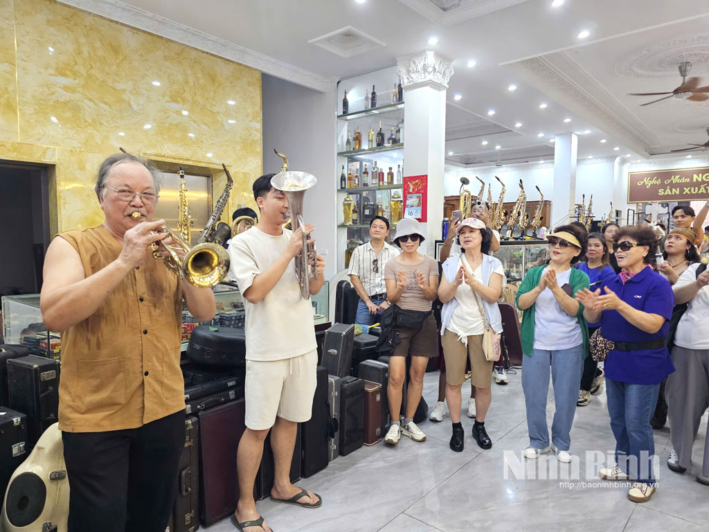 Foreign visitors visit trumpet making village in Hai Anh commune.